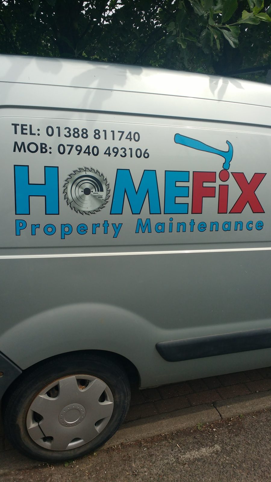 The side of the silver Home Fix van with the HOMEFiX logo and phone numbers